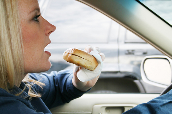 woman-eating-bagel-in-car